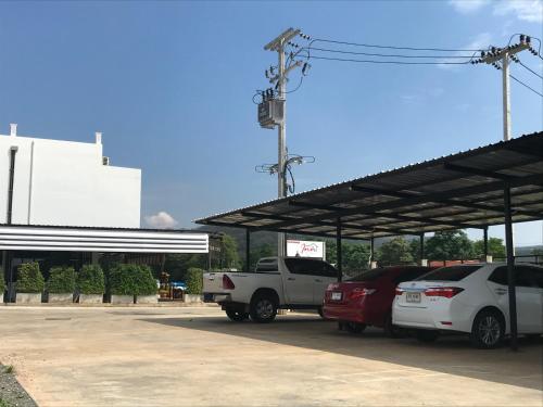 a gas station with cars parked in a parking lot at INN MY PLACE in Pak Chong