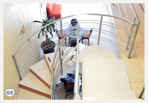 a spiral staircase with a table and chairs on it at Hotel Gesa in Villa Corona