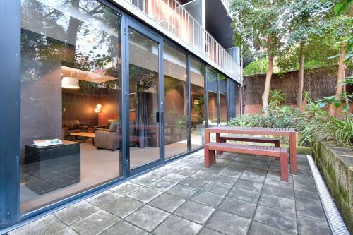 a bench sitting on a patio in front of a building at Riverview on Mount Street in Perth