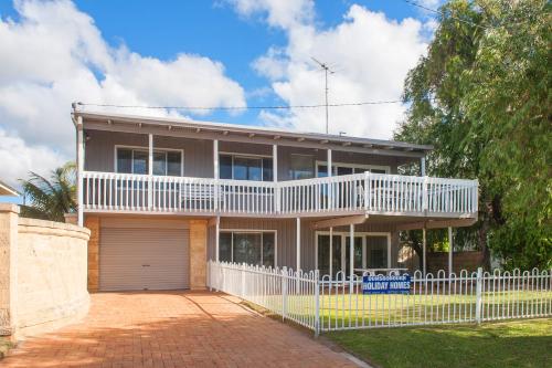 a house with a white fence in front of it at Bay Vista in Quindalup