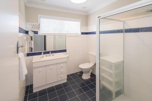 a bathroom with a toilet and a sink and a shower at Bay Vista in Quindalup