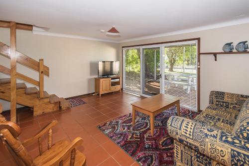 a living room with a couch and a table at Bay Vista in Quindalup
