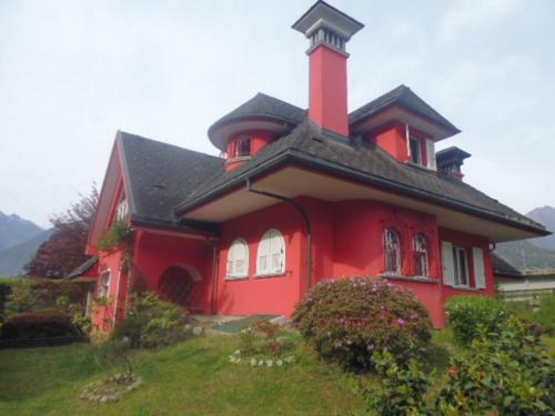 a red house with a tower on top of it at A casa di Lara in Beura