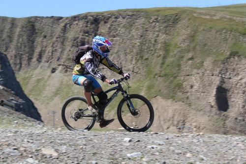 a man riding a bike on a rocky hill at Résidence : Le Crystal Chalet in Les Deux Alpes