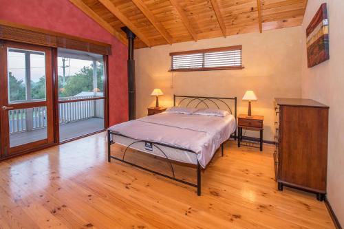 a bedroom with a bed and a large window at Ultramarine in Dunsborough