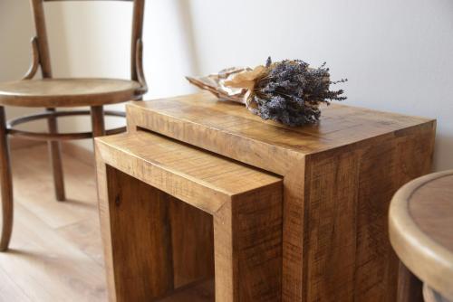 a wooden table with a plant on top of it at Statek Krkavčí Hora in Nižbor