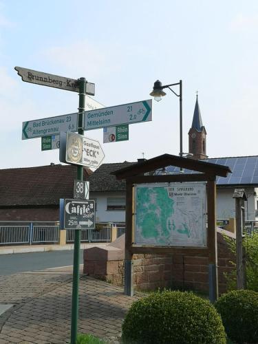 a street sign with street signs on a pole at Sinnglück in Obersinn