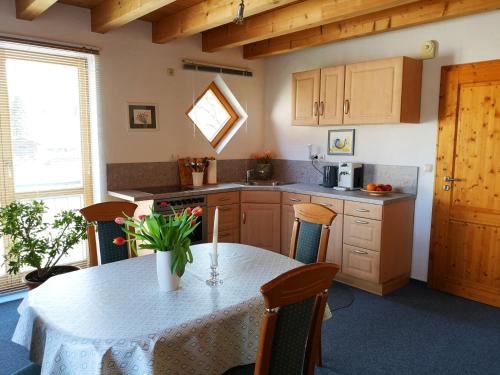 a kitchen with a table with chairs and a counter top at Sinnglück in Obersinn