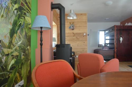a dining room with orange chairs and a table at Das Nest in Eisenstadt
