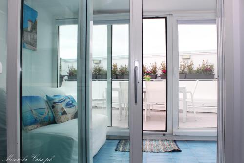 a room with sliding glass doors leading to a balcony at La Casa di MaPi in Salerno