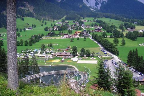 a town in the mountains with a roller coaster at Landhaus Ramsau in Ramsau am Dachstein