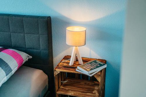 a lamp on a table next to a bed at Walpurgis Hexe in Braunlage