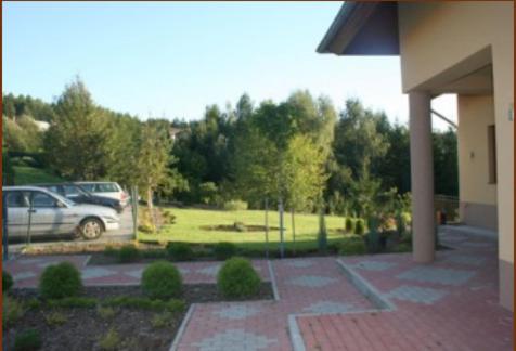 a car parked in a parking lot next to a park at Pokoje Gościnne Monti in Kudowa-Zdrój