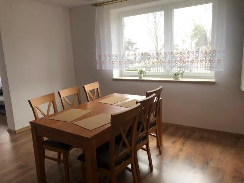 a dining room with a wooden table and chairs at RAMAR in Bodzentyn