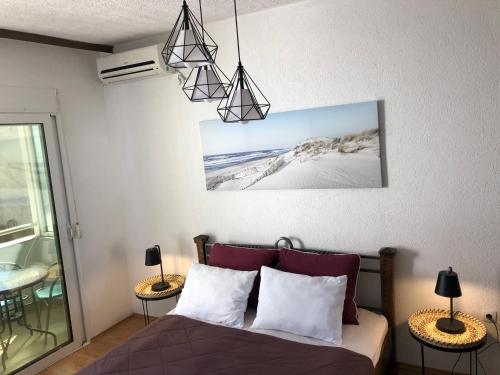 a bedroom with a bed with two tables and two lamps at Casa Alea in Ulcinj