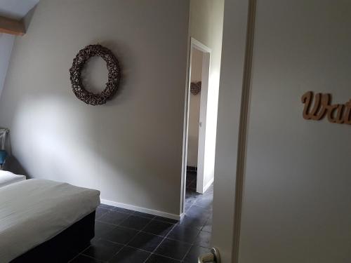 a bedroom with a wreath hanging on the wall at B&B de Remketting in Slijk-Ewijk