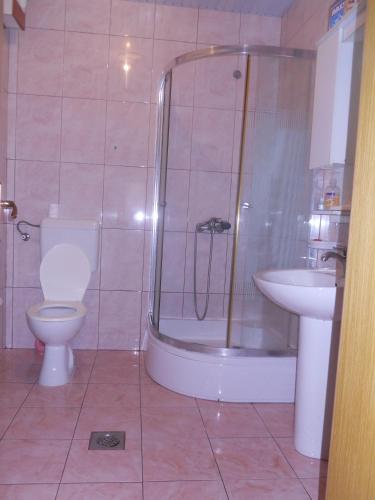 a bathroom with a shower and a toilet and a sink at Nikolic Apartments - Ohrid City Centre in Ohrid