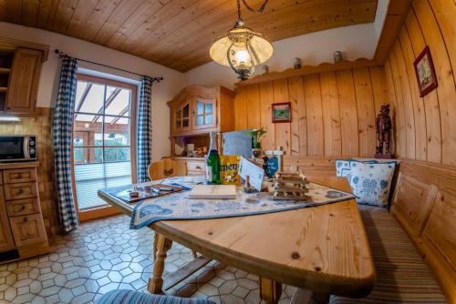 a kitchen with a table in a room with wooden walls at Ferienwohnung Wörnerblick in Mittenwald