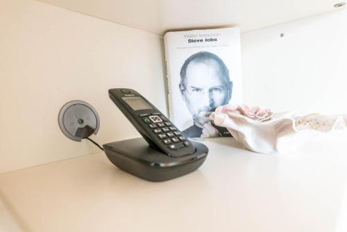 a remote control sitting on a desk next to a book at Ferienwohnung am Ilztal in Hutthurm