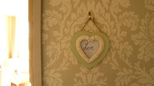 a heart shaped plaque hanging on a wall at Château de Perpezat in Apchat