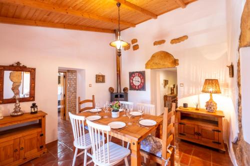 a dining room with a wooden table and chairs at Villa Monte Algarvio - Private Heated Pool - wifi in Tunes