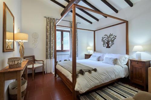 Кровать или кровати в номере La Panoramica Gubbio - Maison de Charme - Casette e appartamenti self catering per vacanze meravigliose!