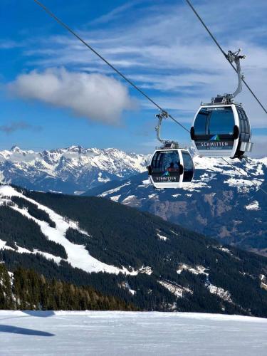 two ski lifts flying over a snow covered mountain at Piesendorf Pad - Oberbichl in Piesendorf