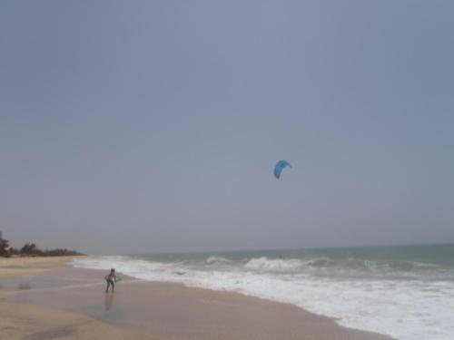a person flying a kite on the beach at Chez medzo et patou in Poponguine