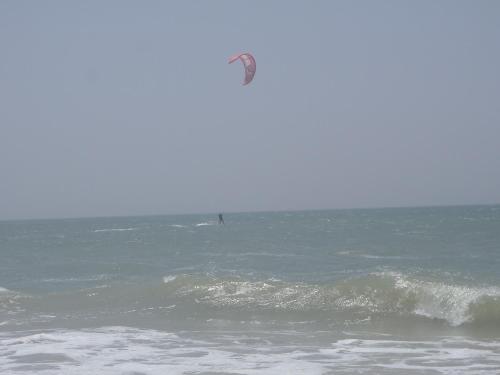 a person flying a kite over the ocean at Chez medzo et patou in Poponguine