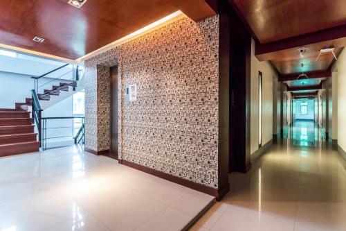 a hallway of a building with a brick wall at 7Q Patong Beach Hotel in Patong Beach
