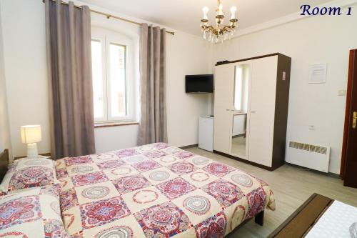 a small bedroom with a bed and a mirror at Old Town Rooms and Apartment in Poreč