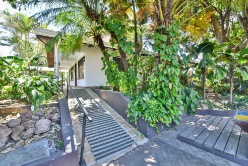 a walkway leading to a house with trees at La Riviera Hotel in San Antonio