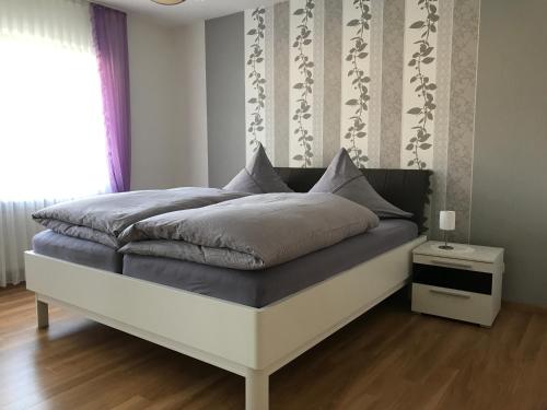 a bedroom with a large bed with a white frame at Ferienwohnung Eifelluft in Daun