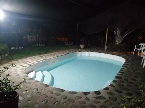a swimming pool in a backyard at night at Casa Campestre Rivera in Rivera