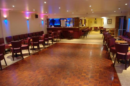 a large room with many tables and chairs at The Wight in Sandown