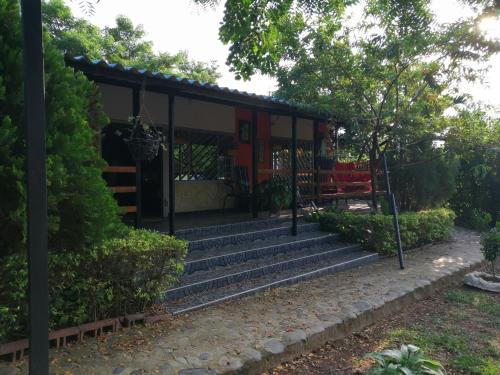 a building with stairs in a park with a bench at Casa Campestre Rivera in Rivera