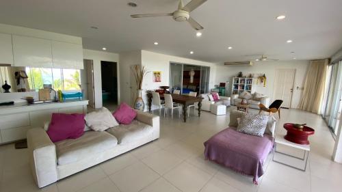 a living room with two couches and a dining room at Kata Top Villas in Kata Beach