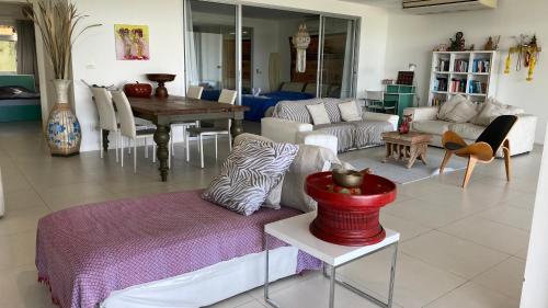 a living room with a couch and a table at Kata Top Villas in Kata Beach