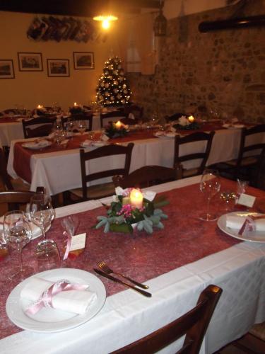 a table in a restaurant with a christmas tree at Cascina Lavaroni in Buttrio