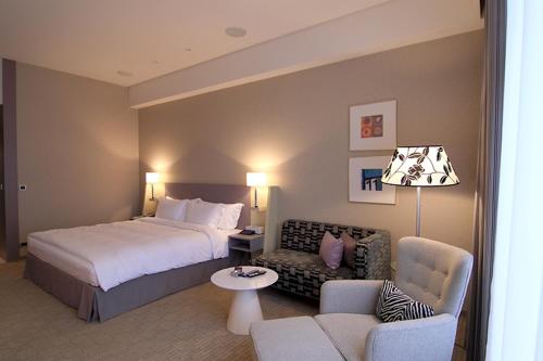 a hotel room with a bed and a living room at Hung's Mansion in Taichung