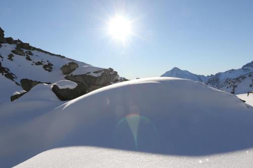 a pile of snow on the side of a mountain at Garni Soldanella in Samnaun