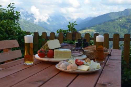 a table with two plates of food and two bottles ofbeer at Oberegghof in Wagrain