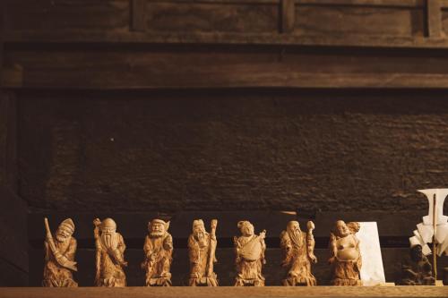 a group of wooden figurines sitting on a table at NIPPONIA Kosuge Village in Kosuge