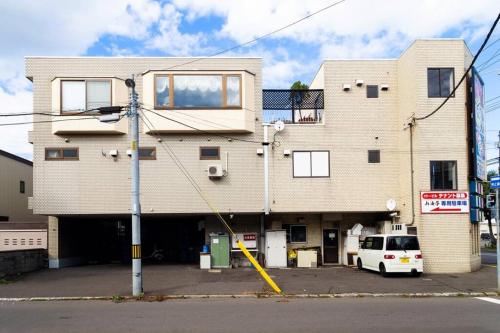 a building with a van parked in front of it at The COMFORIA in Sapporo