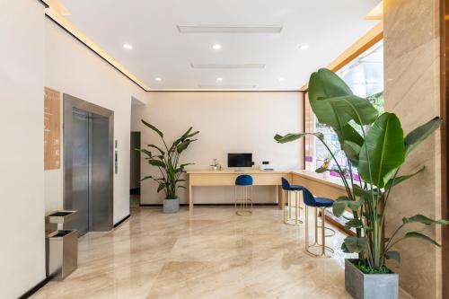 an office with a desk and chairs and a plant at Lan Hotel (Kuanzhai Alley) in Chengdu