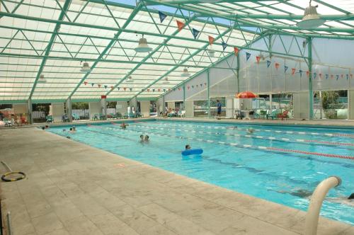 a large swimming pool with many people in it at Logos hotel in Yad Hashmona in Yad Hashmona
