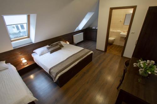 a hotel room with a bed and a bathroom at Smrekarjeva Domačija in Postojna