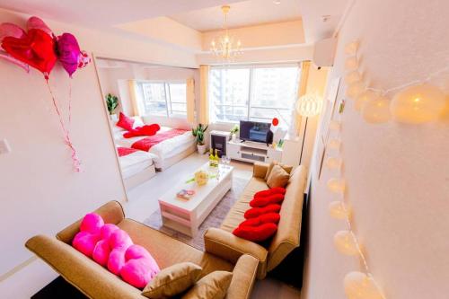 a living room with two couches and a living room with pink at LOVELY in Sapporo