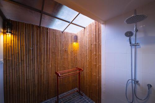 
a bathroom with a bench and a shower stall at Siam Bay Resort in Ko Chang
