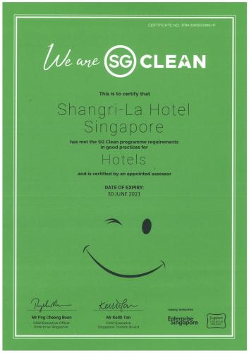a green sign with a smiley face on it at Shangri-La Singapore in Singapore